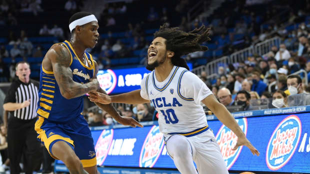 Nov 9, 2021; Los Angeles, California, USA;  UCLA Bruins guard Tyger Campbell (10) is fouled by Cal State Bakersfield Roadrunners guard Shaun Williams (1) as he drives to the basket in the second half at Pauley Pavilion. Mandatory Credit: Jayne Kamin-Oncea-USA TODAY Sports